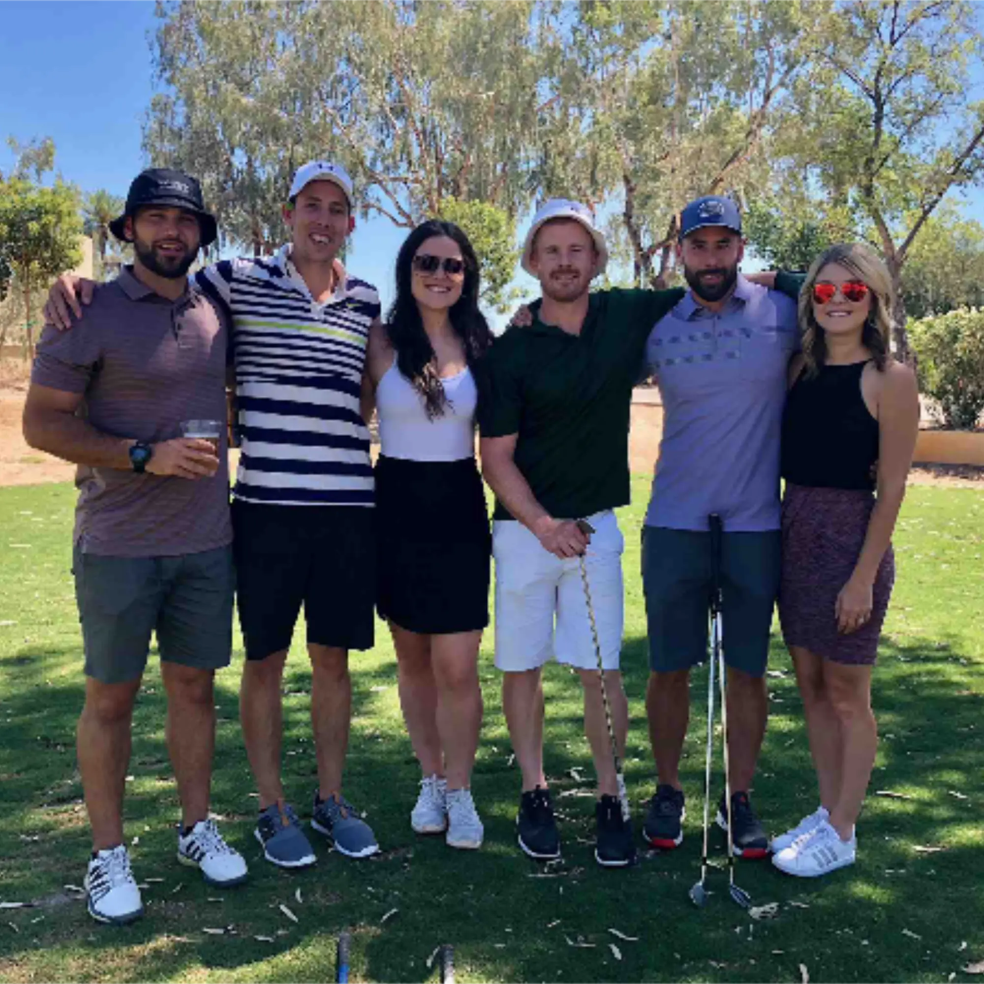Six tournament participants posed together on the course