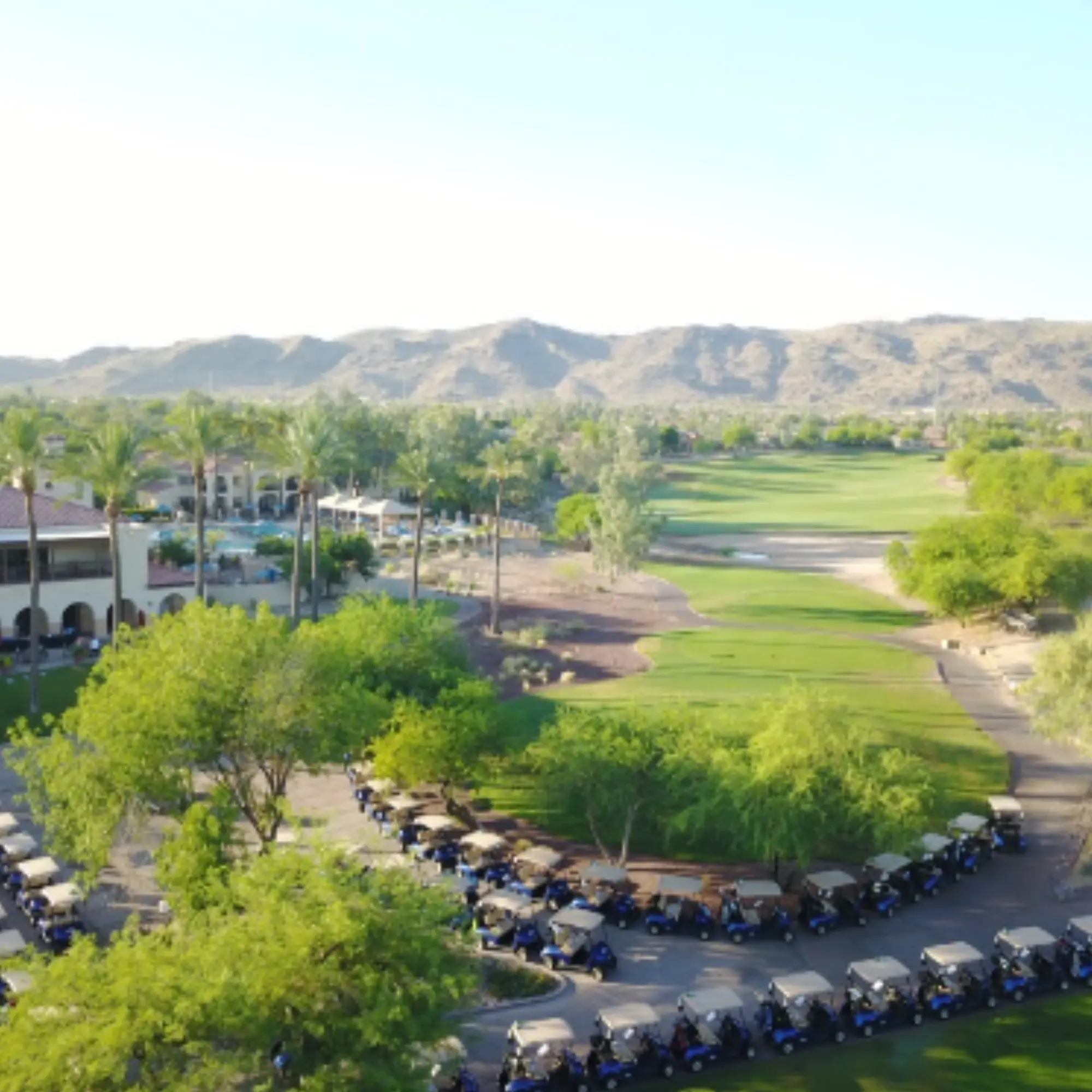 Aerial of The Legacy Golf Club clubhouse with rows of golf carts staged for the shotgun start