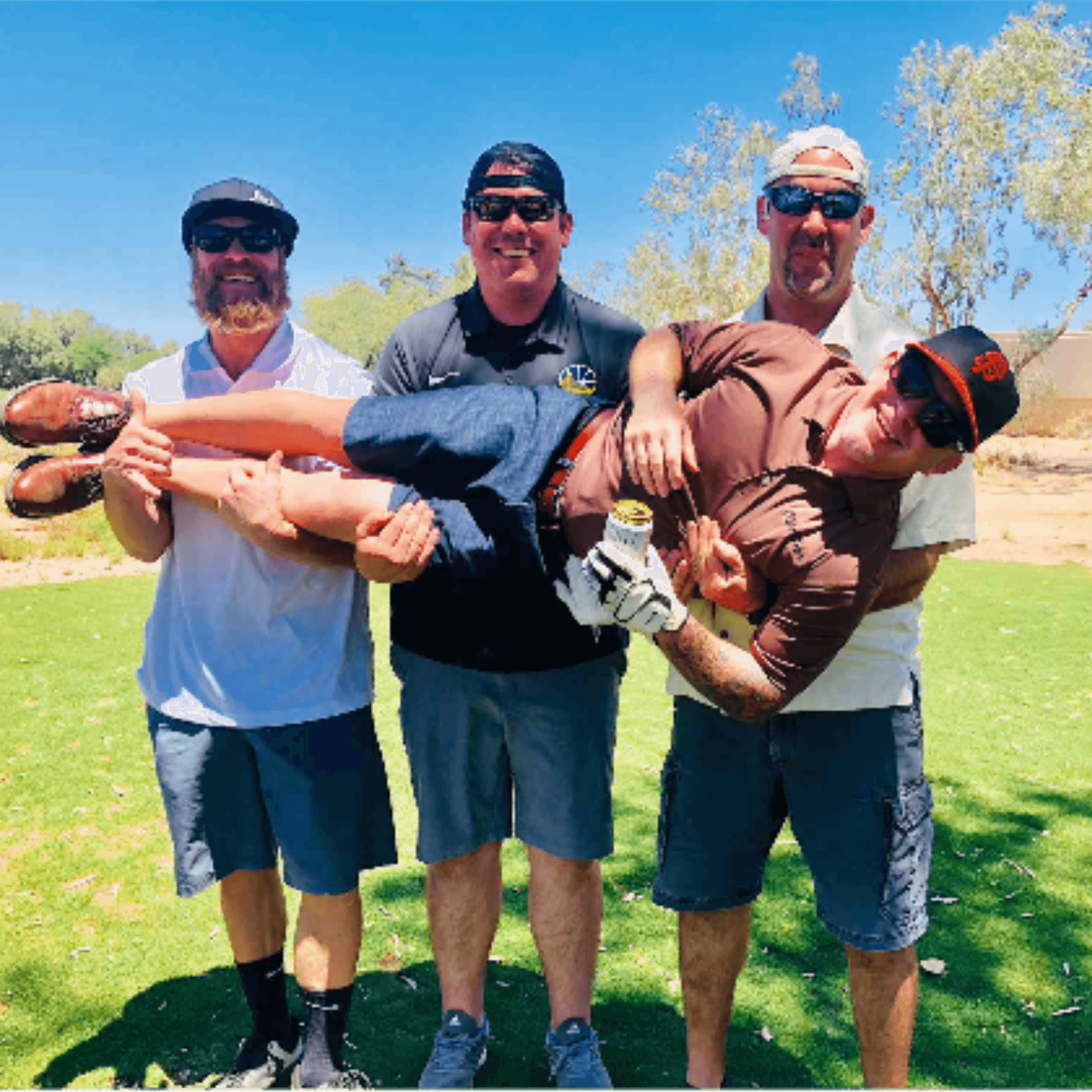 Four tournament participants playfully carrying a fifth horizontally